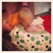 20 month old Kash, kisses his baby brother.